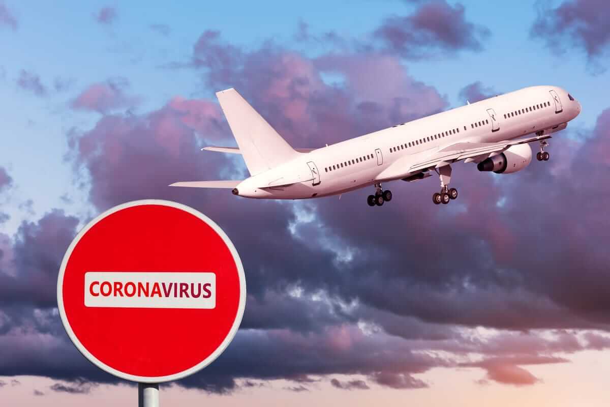 Aircraft taking off with coronavirus warning sign